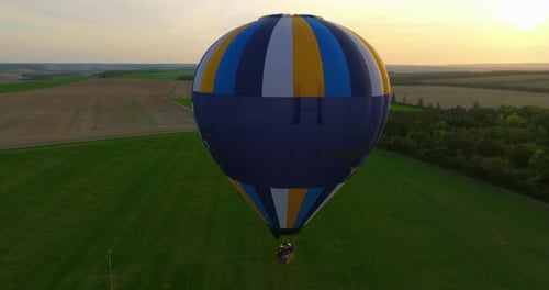 Top View of Hot Air Balloon Flying Above Green Landscape US Drone Shot Balloon Concept of Adventure