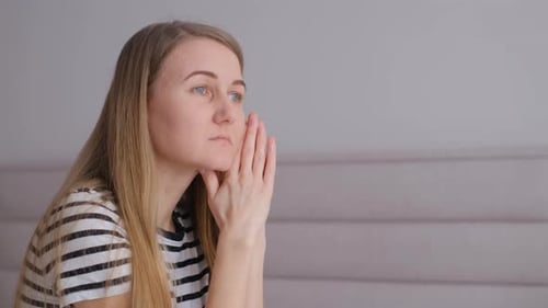 Woman Resting Chin in Hands Thinking Indoors