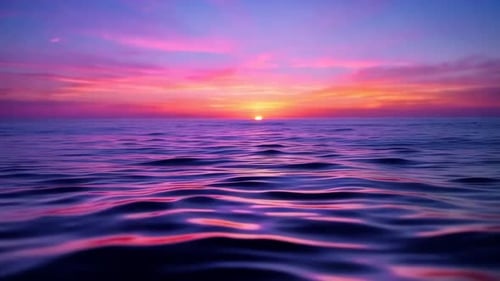 Ocean sunset with pink and purple sky reflection