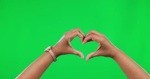 Hands Form Heart Shape Against Green Screen
