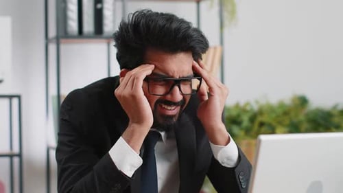 Tired Indian Business Man Suffering From Headache Problem Tension Migraine Stress at Home Office