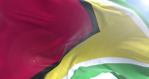 Guyana Flag Waving Against Blue Sky