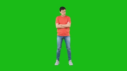 Man Scowling with Arms Crossed on Green Screen