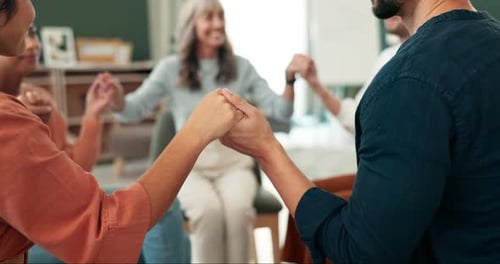 Counseling, group therapy and people holding hands at rehabilitation center for recovery