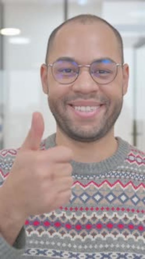 Man Giving Thumbs Up in Office Setting