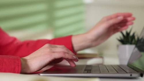 Woman Typing on Laptop Computer at Home Office