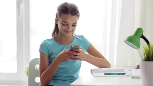 Teen Girl Using Phone Indoors at Desk