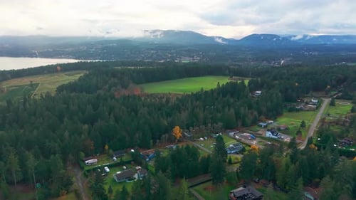 Scenic Aerial View of Misty Mountains Lush Forests and Coastline