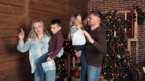 Family Dancing near Christmas Tree Celebration