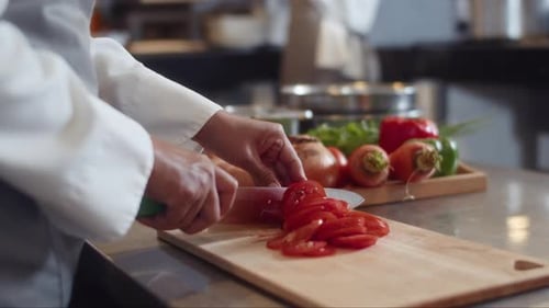 Unrecognizable Sous Chef of Cold Preparation Area Cutting Vegetables