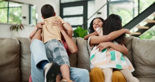 Happy Family Embraces on Living Room Couch