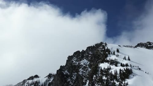 Snowy Mountain Peak. Blue sky and clouds. British Columbia, Canada.