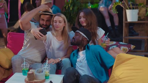 Young Adults Taking Selfie at Outdoor Party at Night