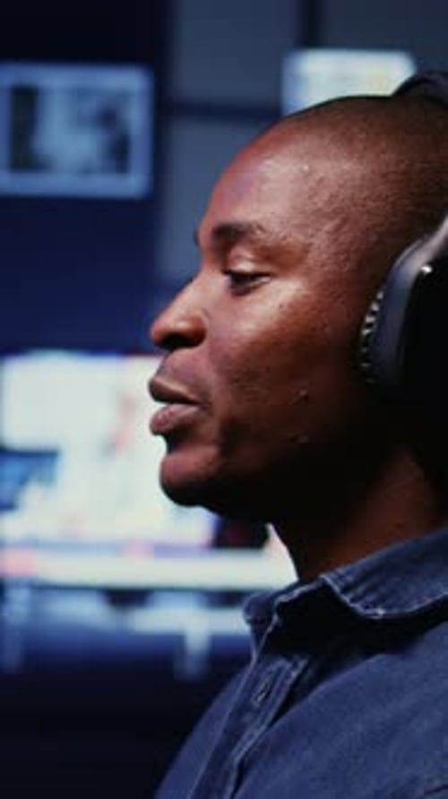 Vertical Video Man Doing Podcasting Session with Professional Streaming Sound Gear Panning Shot