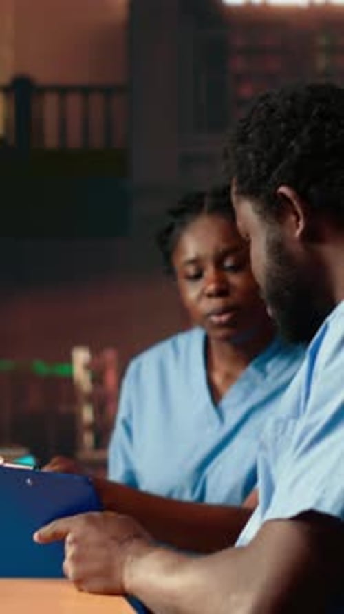 Vertical Video Future Nurses Studying Anatomy Class Notes in a University Library
