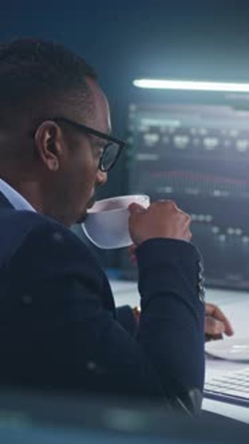 African American IT Technical Specialist Works on Computer