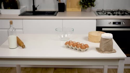 Baking Ingredients on a White Table in Kitchen