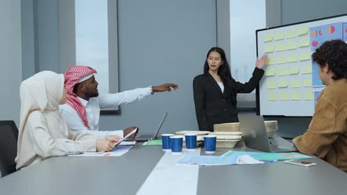 Diverse Team Brainstorming Together in Modern Office