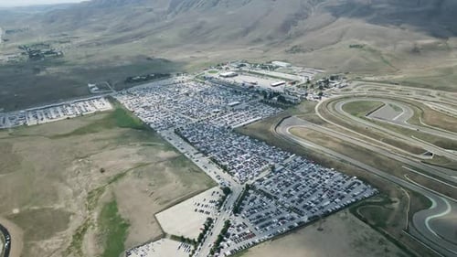 aerial footage of F1 track beside a huge car parking