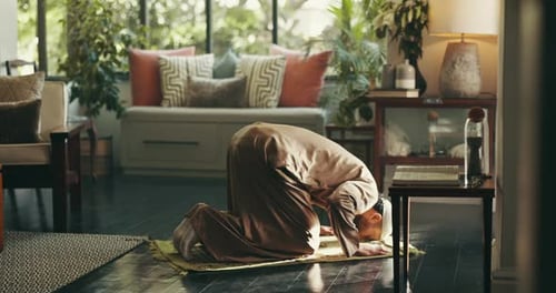 Islamic, religion and man with praying on mat in home for spiritual worship