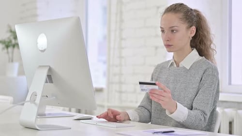 Woman Using Credit Card For Online Shopping