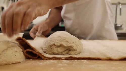 a chef makes bread in a bakery