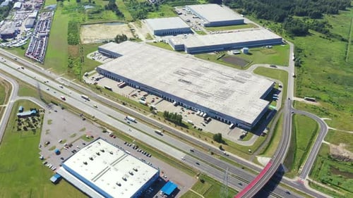 Aerial top view of the large logistics park with warehouse, loading hub with many semi-trailers truc
