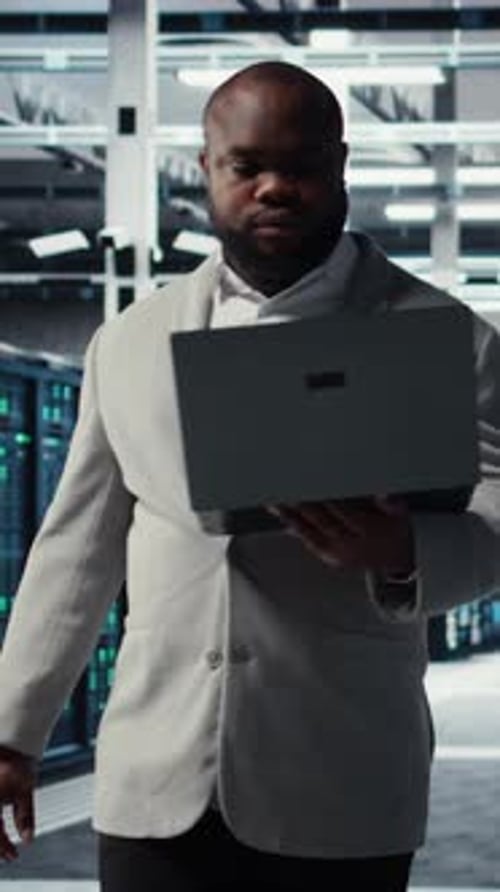 Vertical Video Data Center System Administrator Reviewing Code for Automation Scripts