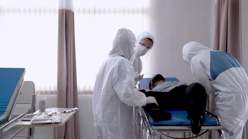 Health Workers Attending to Patient in Hospital