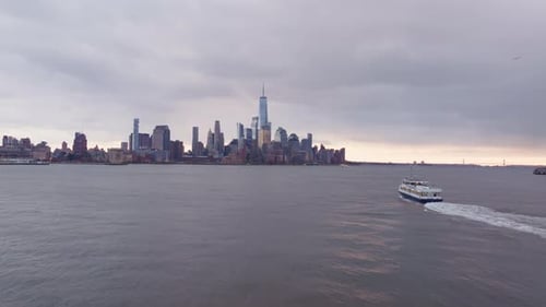 Ferry Traversing Hudson River with Lower Manhattan's Skyline Skyscrapers and One World Trade Center