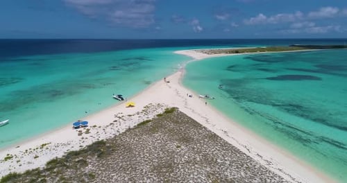 Aerial Turnaround View of a Tropical Island with People Enjoying the Beach