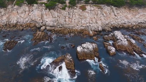 Aerial View of the Pacific Ocean Waves Hitting the Cliff Rocks
