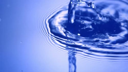 Water Droplets Create Ripples in Pool of Liquid