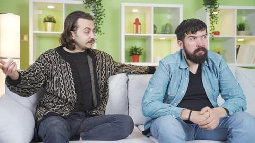 Two Men Talking and Sitting on Couch