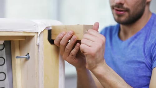 Furniture, Home and Moving Concept - Close Up of Male Hands Assemblying