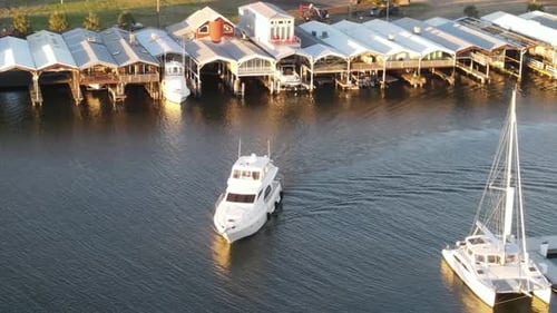 Luxury Yacht Charter Arrived At Marina After Cruising In The Lake At Sunset. - aerial