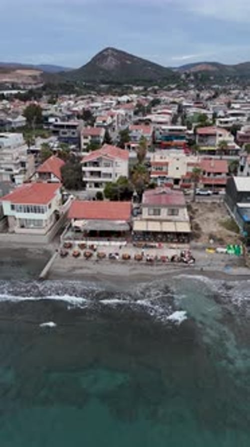 4K Drone Footage of a Seaside Venue with Outdoor Tables and Coastal View