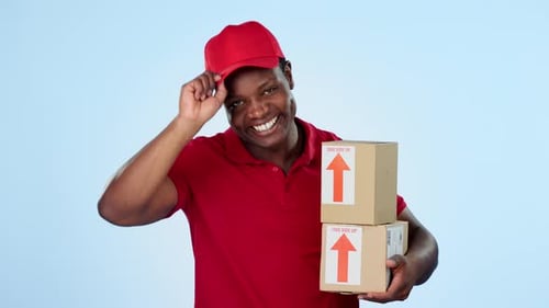 Boxes delivery, greeting or happy man in studio for logistics courier service