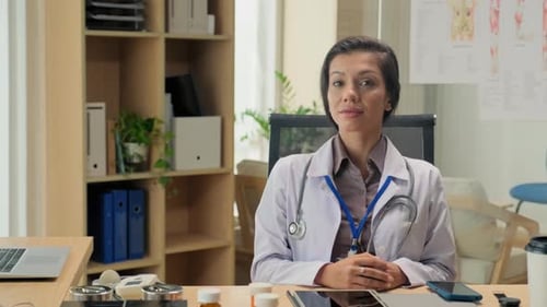Female Doctor Smiling in Bright Medical Office