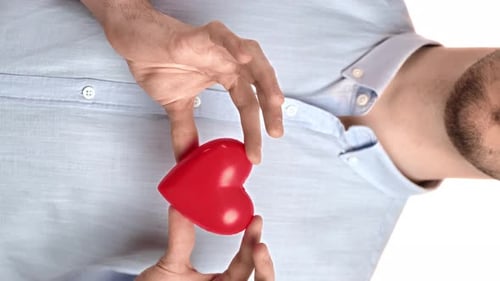 Man Holding Red Heart in His Hands