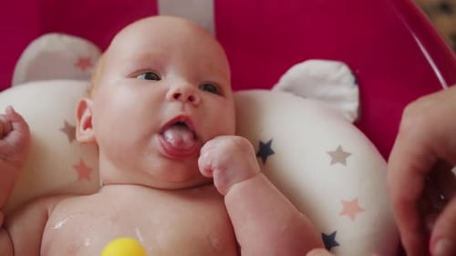 Mother Playing with Her Baby in a Bathtub Shallow Depth of Field