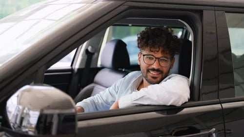 Arabian Customer Showing New Car Key While Sitting Inside