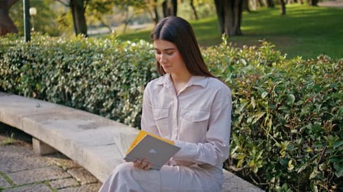 Romantic Girl Reading Book in Green Park Relaxed Student Study Sitting Bench