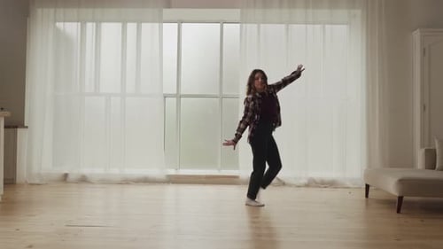 Woman Dancing Freely in Open Home Room