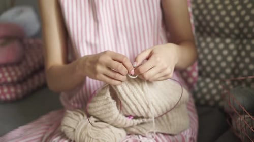 Young Woman Knitting Yarn at Home Close-up