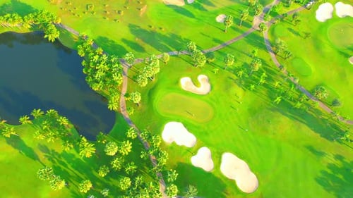 Drone flying over golf course in the morning with sunshine