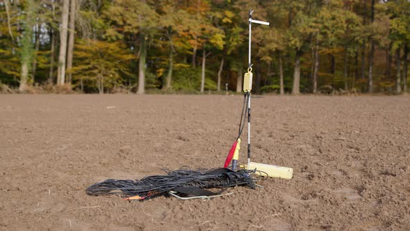 High Resolution Video of a Geophone standing on a field. Next to the ...