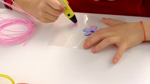 Child Creating Art with 3D Pen and Filament