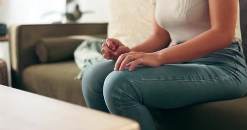Woman sitting on sofa at home