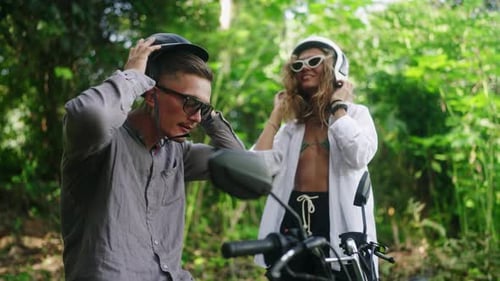 Couple Preparing for Moped Ride in Lush Forest